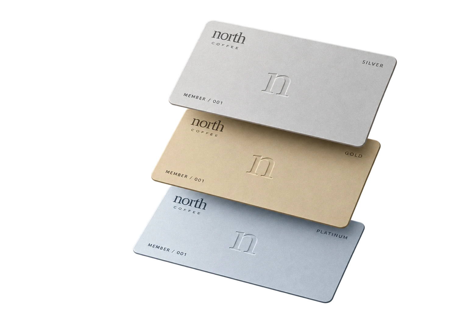 Three floating North Coffee membership cards in Silver, Gold and Platinum